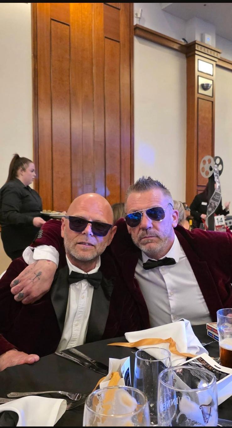 Magic and Tricky in sunglasses at a dinner table
