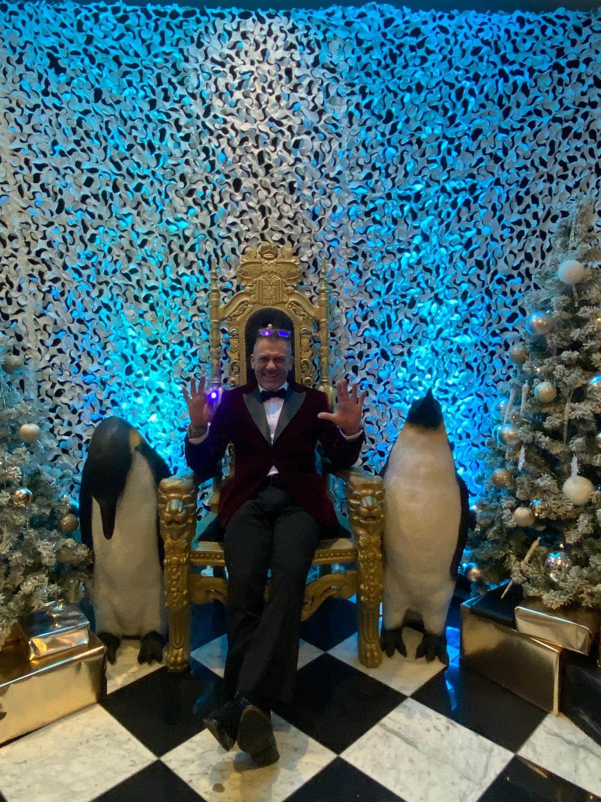 Magic on a golden throne between two penguins